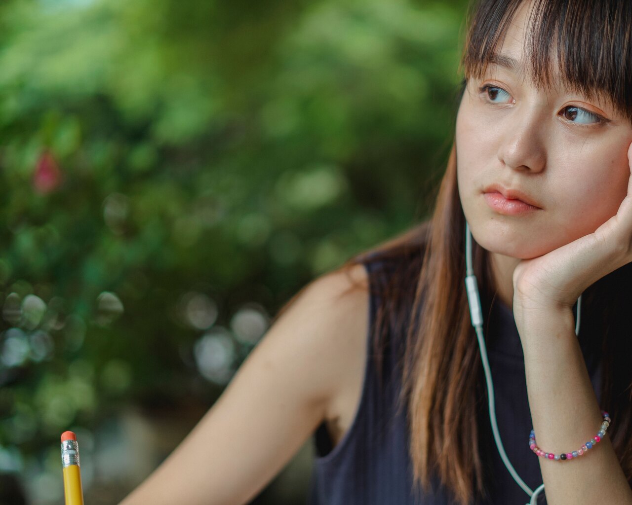 Thoughtful language learner listening with earphones