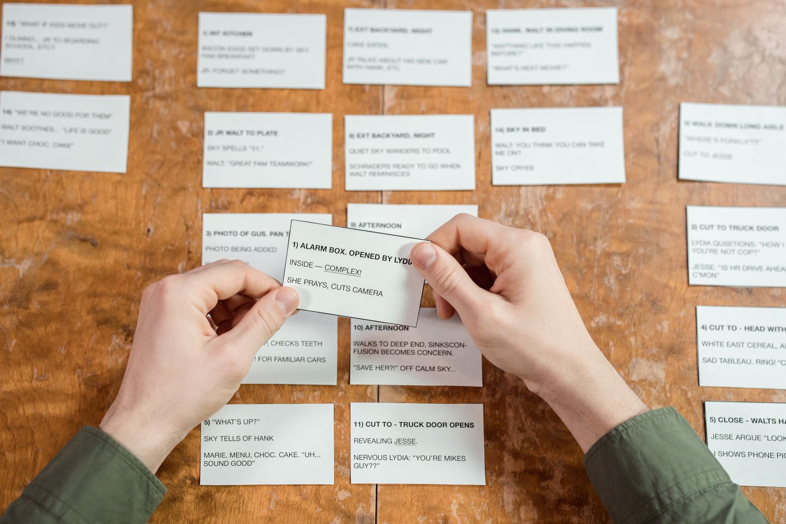 Hands arranging vocabulary cards on a desk